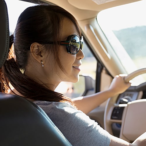 Woman with sunglasses on driving 